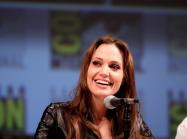 Angelina Jolie sits at a comic con pannel 