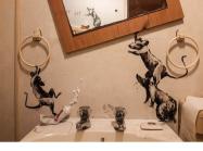 Banksy rats run amok in a bathroom