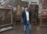 José Luis Lazarte Luna, Assistant Conservator in Paintings Conservation, who was born and raised in Lima, Peru, stands in front of several paintings in the Cuzco School style that were recently gifted to The Met 