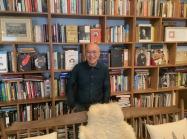 Phong Bui in front of his many bookshelves. 