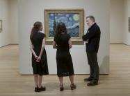 group looks at Starry Night on wall in gallery