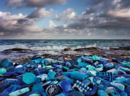 photograph of blue plastic arranged on a beach
