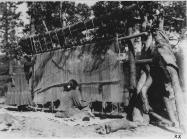 Navajo women weaving a rug c.1930-1938. Source.