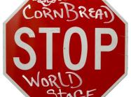 Art by CornBread: Stop Sign with "Cornbread" sprayed above "STOP" and "World Stage" Below