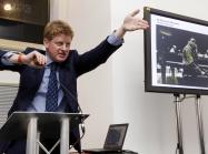 Sotheby's auctioneer Adrian Biddell gesticulates as he takes bids