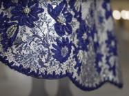 Still #2 from Met Preview Video of the exhibition, In America- An Anthology of Fashion. Features a blue, bejeweled dress hem