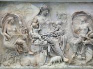 The so-called Tellus panel from the Ara Pacis, ca 9 BCE. Here a goddess, likely the personification of Pax (Peace) or Tellus (the Earth), is surrounded by natural fecundity and symbols of plenty. This panel combined with the other mytho-historical images of the building are an imagery combination of commemorative Roman art. The Ara Pacis has been reassembled in the Museo dell’Ara Pacis in Rome. 