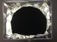 Wrinkled aluminium foil with a portion—equally wrinkled—coated in Vantablack. Courtesy Wikimedia Commons. Photo Anna Frodesiak and Surrey NanoSystems.