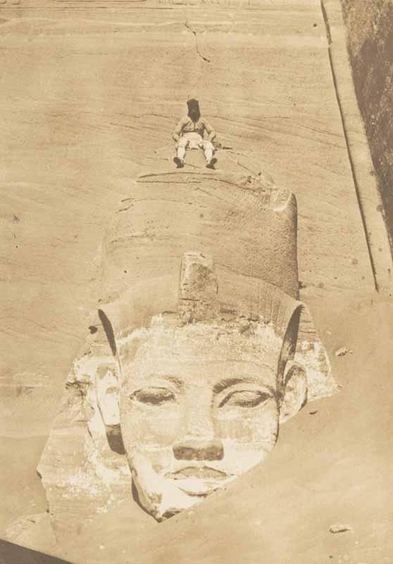 Photo of Maxime du Camp on ancient Egyptian statue by Gustave Flaubert, who he traveled across the Middle East with to record the Pyramids and other wonders by Photograph for the first time so others could see the real deal and not a drawing of such.
