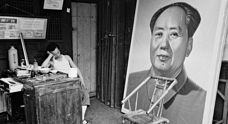 A painter naps at a craft art store specializing in ideological portraits, Chengdu, Sichuan province, 1980.