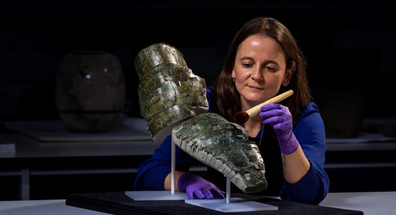 Conservator Bethan Bryan with the Roman arm guard