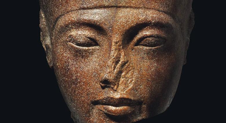 An Egyptian Brown Quartzite Head of the God Amen with features of the Pharaoh Tutankhamen. New Kingdom, 18th Dynasty, Reign of Tutankhamen, circa 1333-1323 B.C.