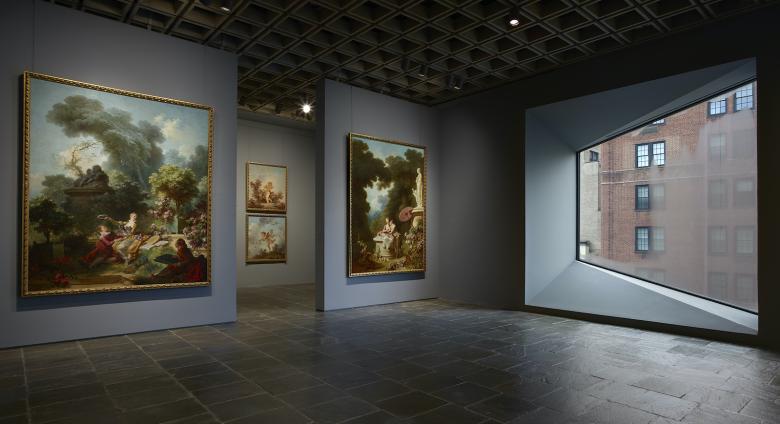 Four grand panels of Fragonard’s series The Progress of Love are shown together at Frick Madison in a gallery illuminated by one of Marcel Breuer’s trapezoidal windows. This view shows two of the 1771–72 paintings, with two later overdoors visible in the next gallery.