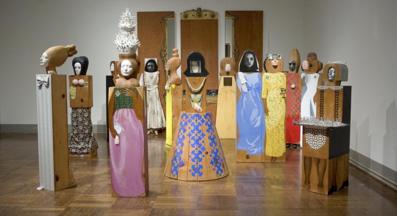 Marisol, The Party, 1965-66. Assemblage of 15 freestanding, life-size figures and 3 wall panels, with painted wood and carved wood, mirrors, plastic, television set, clothes, shoes, glasses, and other accessories. Dimensions variable. 