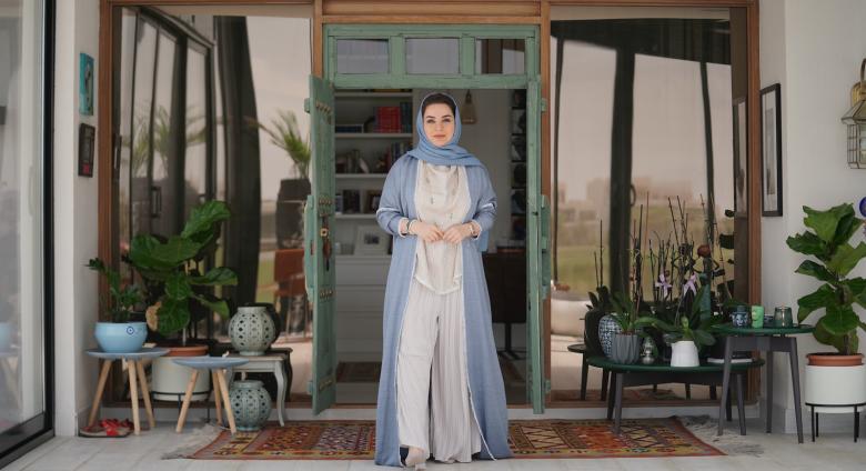 Omani artist Alia Al Farsi stands at door. Image by Burair Alkishri