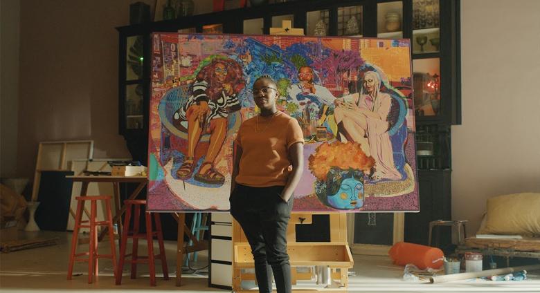 Artist Amani Lewis stands in front of work in promo video for google partnership to promo black-owned businesses