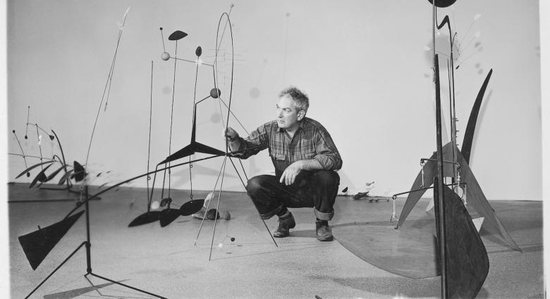 Publicity photograph of Calder during the installation of Alexander Calder. black and white