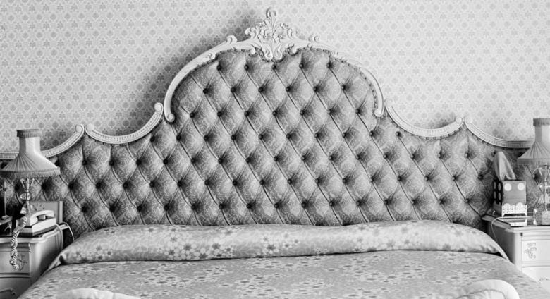 black and white photo of a bed 