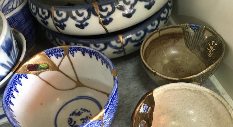 detail photo of a collection of pottery wares repaired via Kintsugi