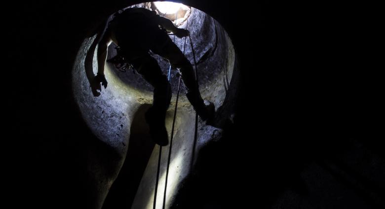 Fabio Fiocchi descends on a roped safety system into a cistern cavern at Vulci. To do such requires training and safety certifications. Credit- Danielle Vander Horst.
