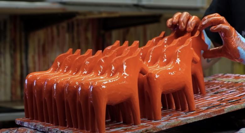 red sculpture horses being painted