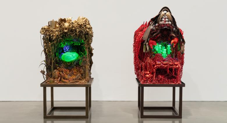 Installation view of Make-Shift-Future, curated by Elliott Hundley at Regen Projects, Los Angeles March 27 – May 22, 2021. two chair-like items holding three dimensional, artistically rendered foliage and glowing, green minerals