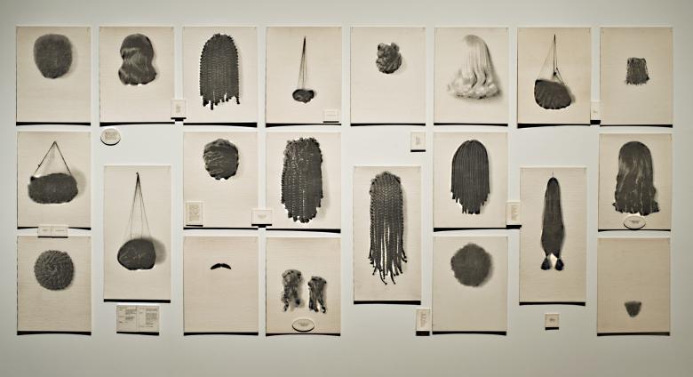 Lorna Simpson art installation of 20 images of wigs hung on a wall