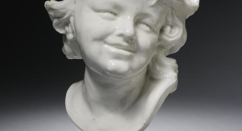 ceramic bust of a laughing child