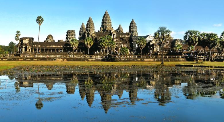 Angkor Wat temple makes up skyline beyond body of water 