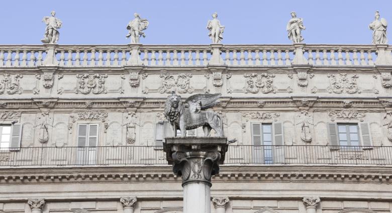 Facade of the Palazzo Maffei, a lion atop a pillar