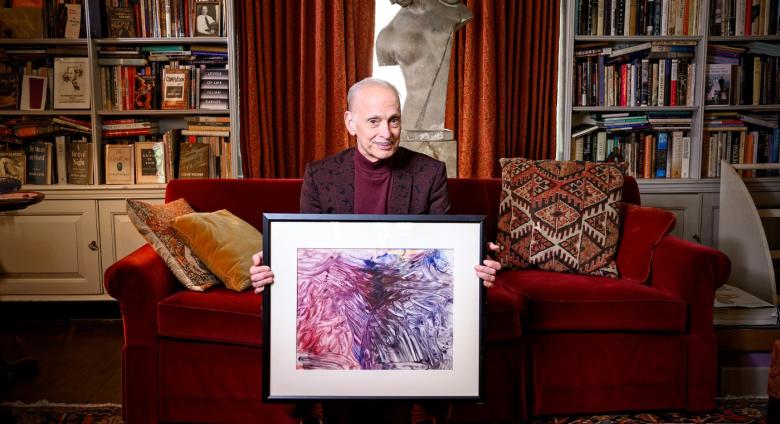 John Waters at home with his "monkey masterpiece."