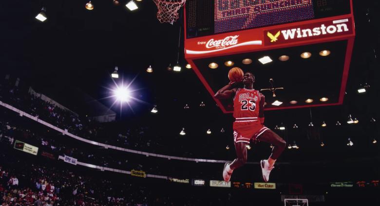photo of Michael Jordan dunking ball, seen from below hoop