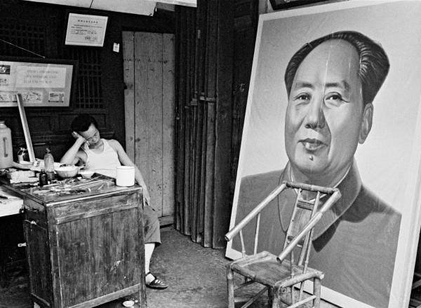 A painter naps at a craft art store specializing in ideological portraits, Chengdu, Sichuan province, 1980.