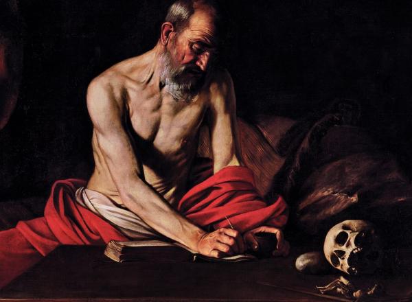Muscular, shirtless Saint Jerome sits wrapped in red fabric, writing as though in transfixed state, atop a table that also bears a skull.