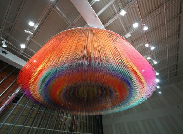 Hanging at the entrance of the SCOPE Pavilion, acclaimed street artist HOTTEA's massive, hanging installation features an eye-catching design made of brightly colored yarn.