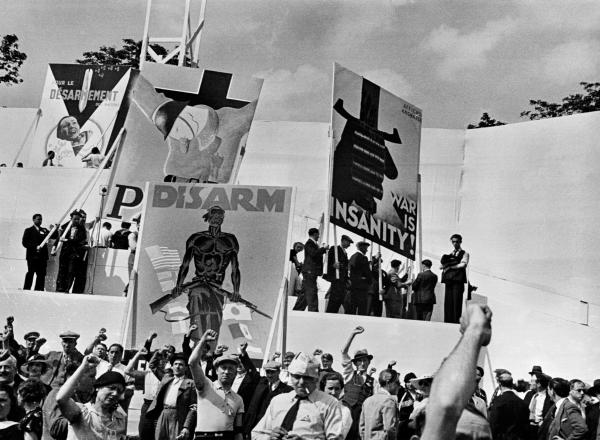 DAVID SEYMOUR black and white photograph of a crowd of people with their fists raised in the air