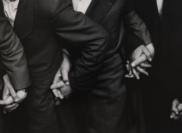 Ken Heyman black and white photograph of four sets of hands holding eachother