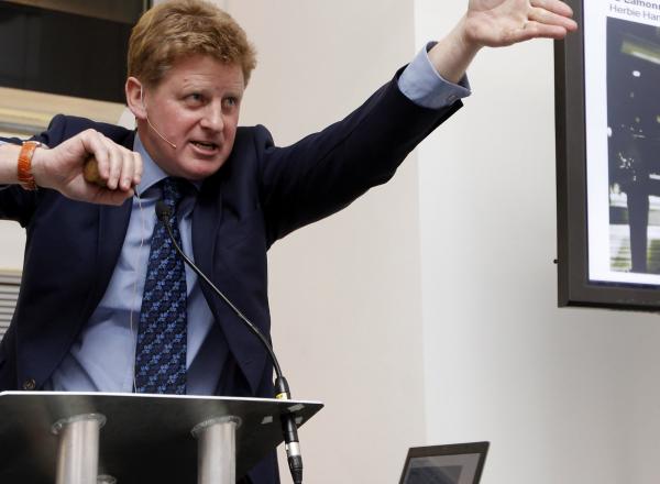 Sotheby's auctioneer Adrian Biddell gesticulates as he takes bids