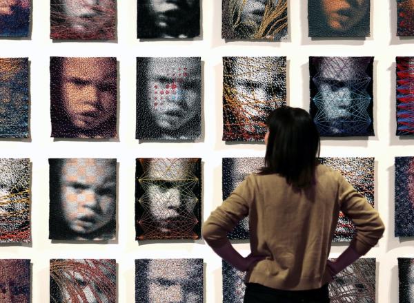A wall of 32 woven portraits 