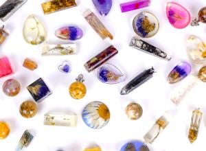 Various resin charms of different shapes and colors on a white background.