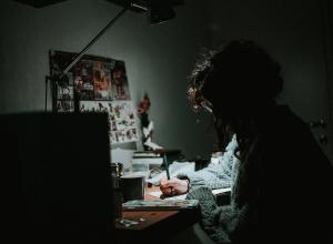 a person sits at a desk with a lamp
