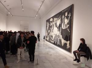 Visitors looking at Pablo Picasso’s Guernica. Source.