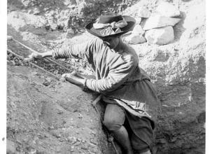 Hilda Petrie descending a ladder into an Egyptian Tomb.