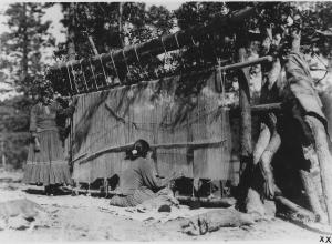 Navajo women weaving a rug c.1930-1938. Source.