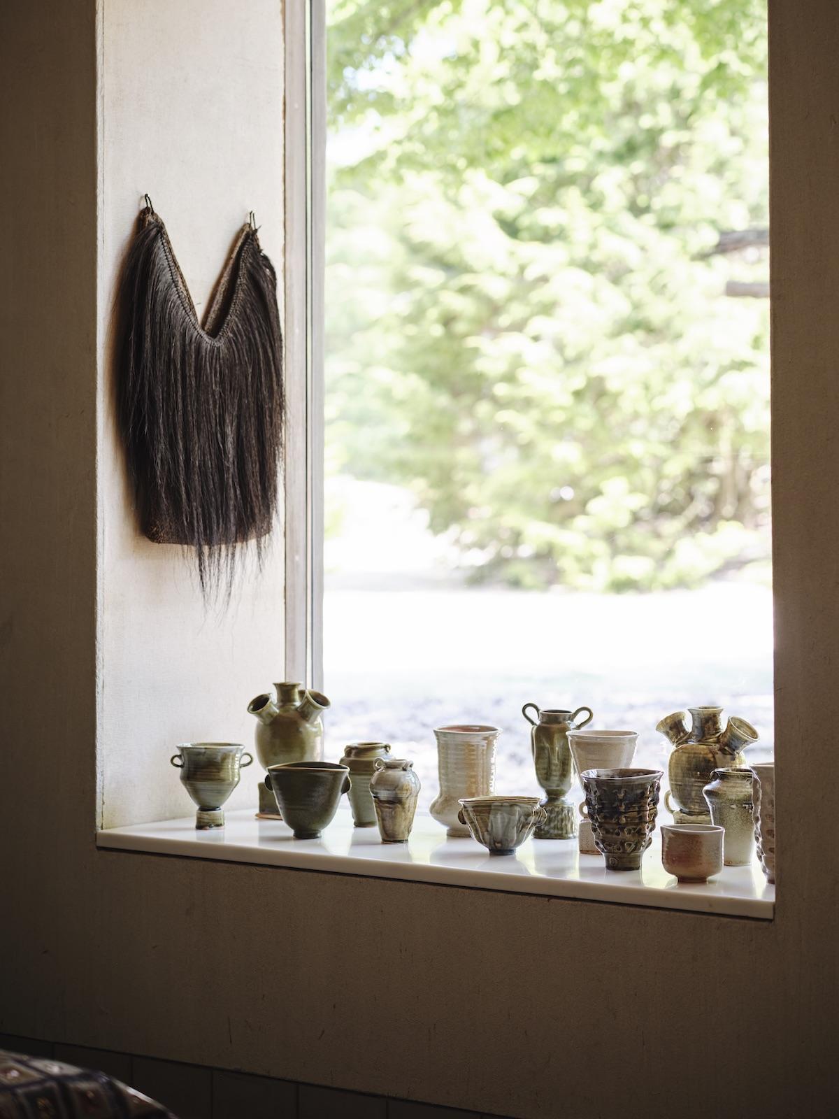 A Summer Arrangement: Object & Thing at LongHouse. LongHouse, East Hampton, New York. Photo by Adrian Gaut. Works pictured: Wood fired ceramics by Frances Palmer arranged in the windowsill inspired by other displays at LongHouse.