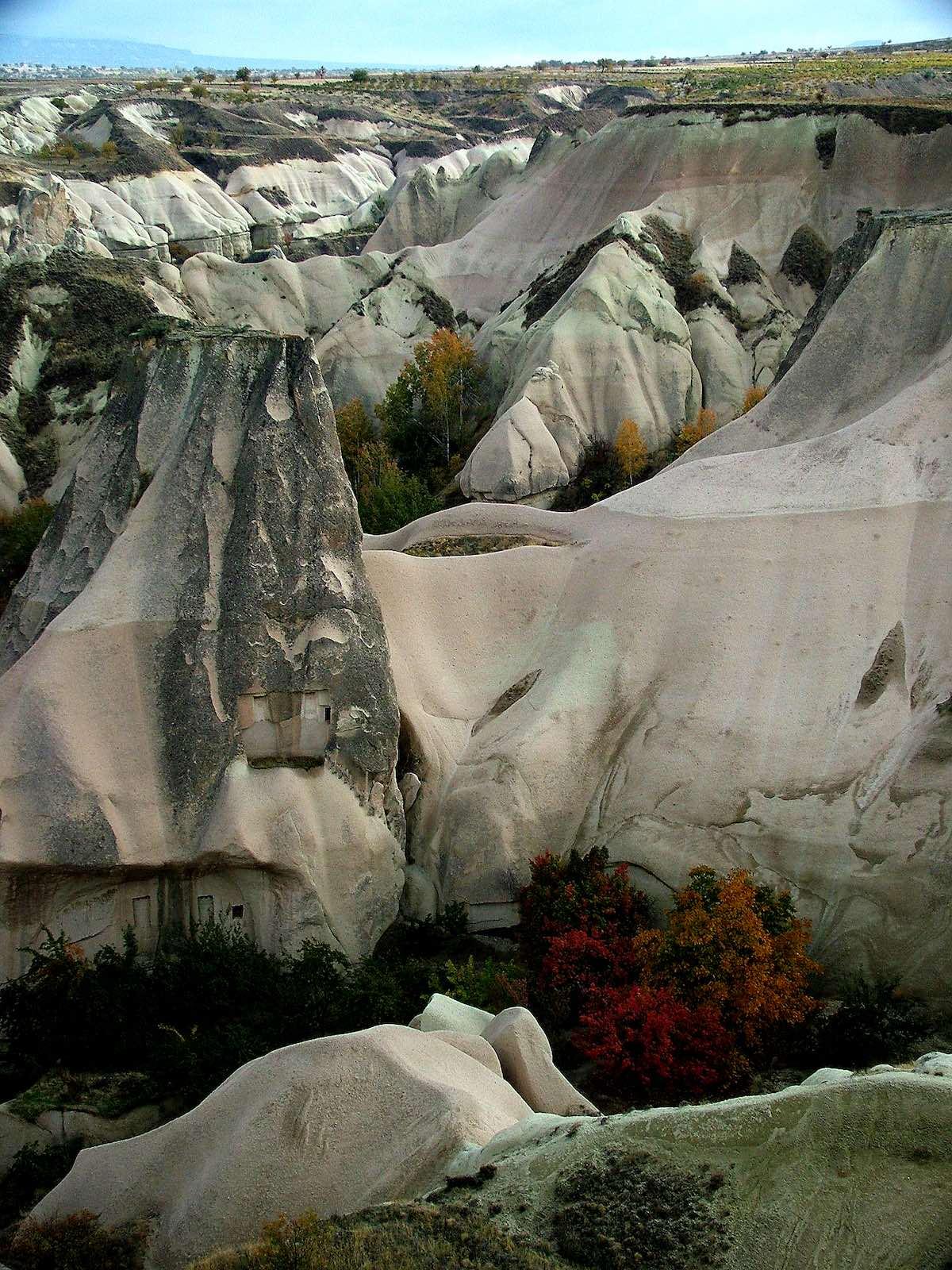 View of Göreme National Park's soft naturally-formed rocky slopes.