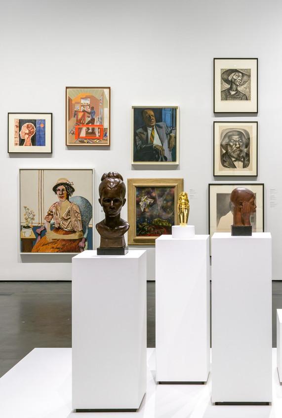 Detail of installation photograph from Black American Portraits, LACMA. Tavares Strachan’s ENOCH is the central gold figurine in the foreground of the image.