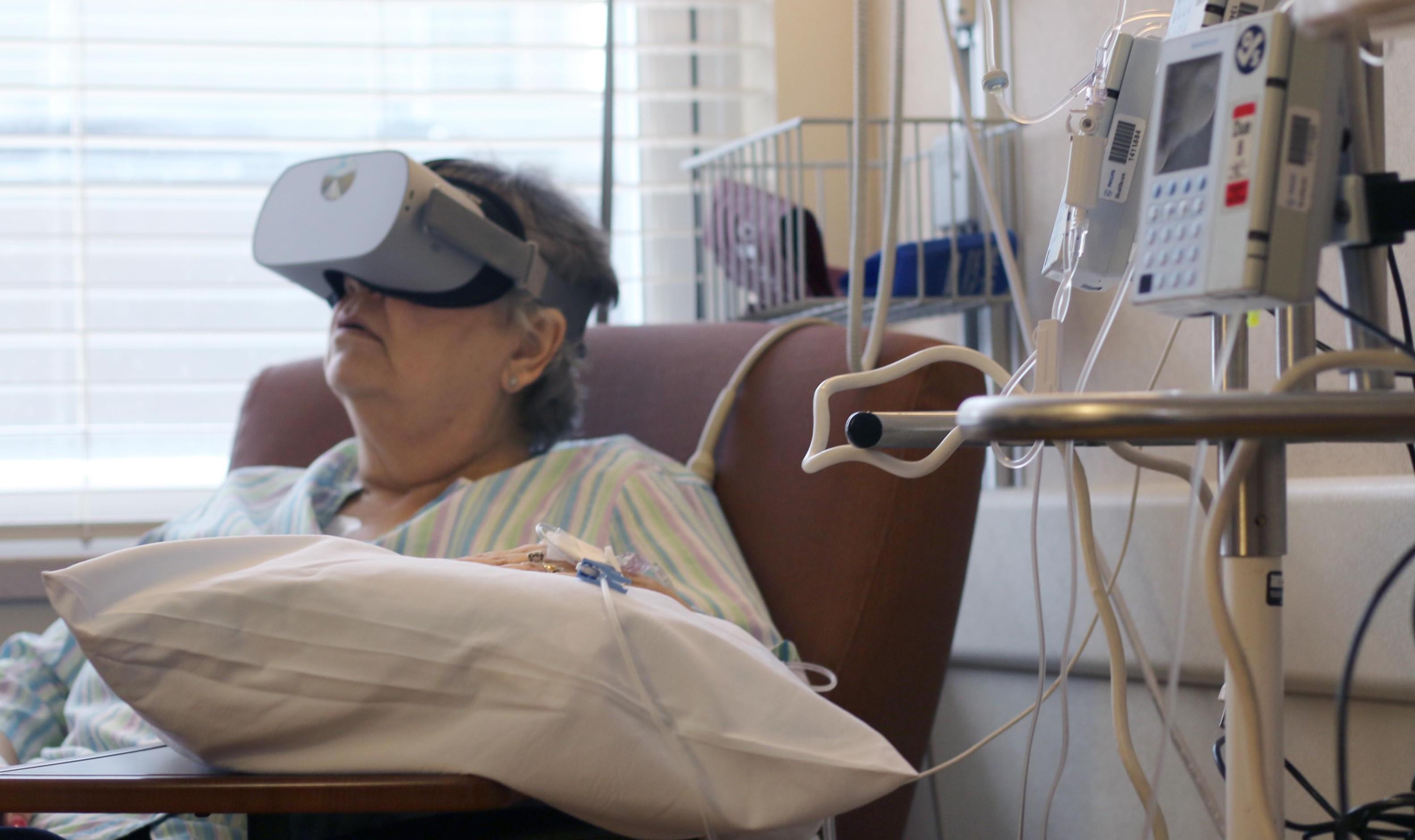 A patient receiving chemo treatments uses VR.