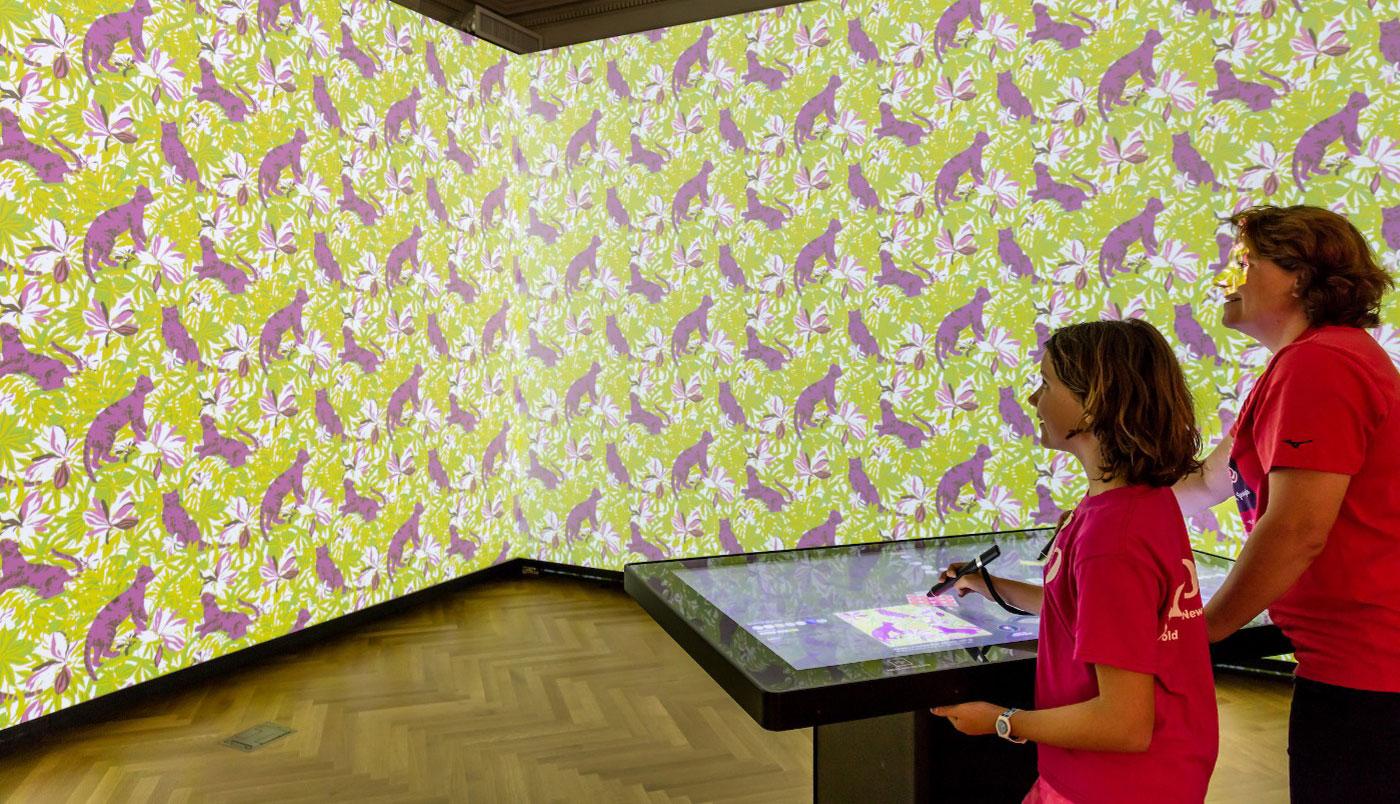 Visitors manipulate the walls using digital technology in the Immersion room at the Cooper Hewitt Smithsonian Design Museum.