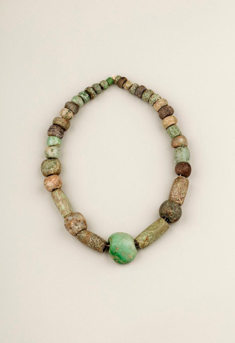 Frida Kahlo's string of irregular Pre-Columbian jade beads with a central pendant carved as a fist. Probably excavated from a Maya site.